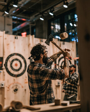 Men in plaid shirts at an axe throwing venue with rustic decor and wooden targets for a night out competition