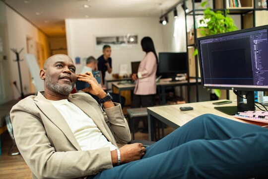 Confident manager on phone in modern office