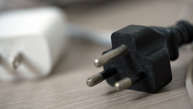 Electrical plugs with circuit breakers and fire-resistant materials for safety