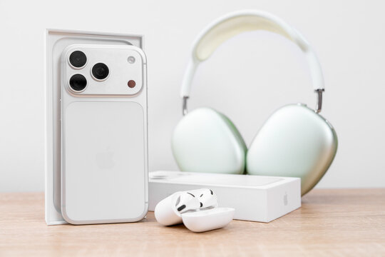Bar, Montenegro: February 6, 2026: White apple iphone 17 pro in open box with green airpods max headphones and wireless earbuds on wooden table, new device unboxing concept