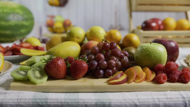 Beautiful cluster of delicious fruit on cutting board in kitchen - medium shot