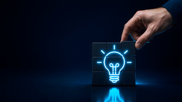 Hand assembling dark cube puzzle with glowing blue lightbulb icon. Concept of digital business strategy, cybersecurity problem solving, and innovative tech synergy.