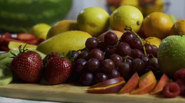 Closeup tracking shot across wet, delicious fruit platter