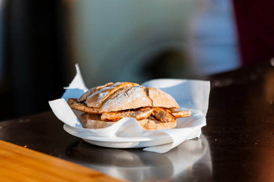 Traditional Portuguese pork bifana sandwich served on rustic bread
