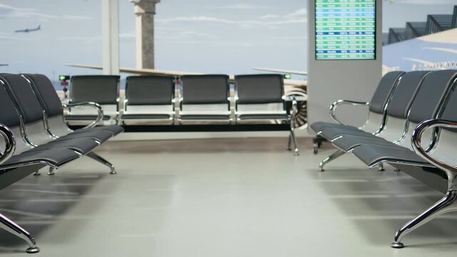 Quiet airport waiting area has no passengers or luggage, with modern chairs and boarding gates inside an empty travel hub before the busy departure period begins in the modern terminal.