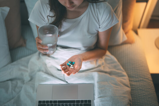 Young adult lonely trauma woman take medicine for mental health therapy from social issue anxiety from digital technology