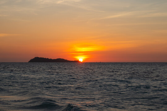 Sunrise Over Ocean With Island Silhouette