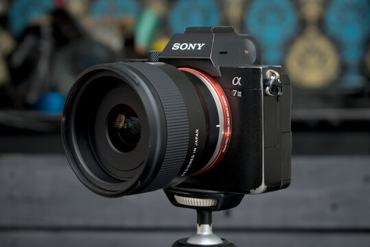 Zapopan Jalisco, Mexico - July 18, 2026: Front angle view of Tamron 24mm F2.8 lens mounted on Sony Alpha 7 III camera