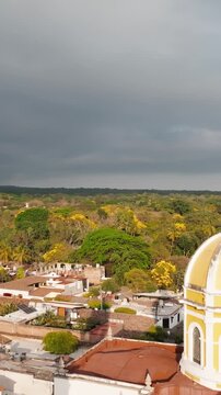 Vertical pullback aerial reveal of San Miguel Arc&aacute;ngel Church and Plaza Principal in Comala, Colima