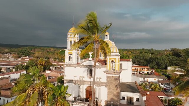 Saint Michael Archangel Church in the historic center of Comala, Colima, Mexico. Aerial daytime panoramic flyover