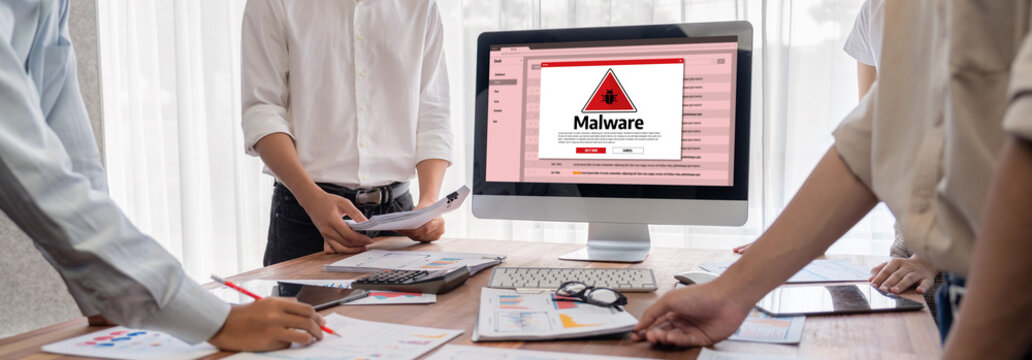 Cyber attacking concept. Malware alert showing on computer screen display scam and threat detection on computer system or online server to be removed brisk.