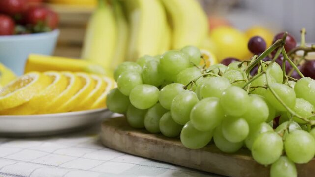 Smooth movement across beautiful, fresh, cut fruit on kitchen counter - closeup