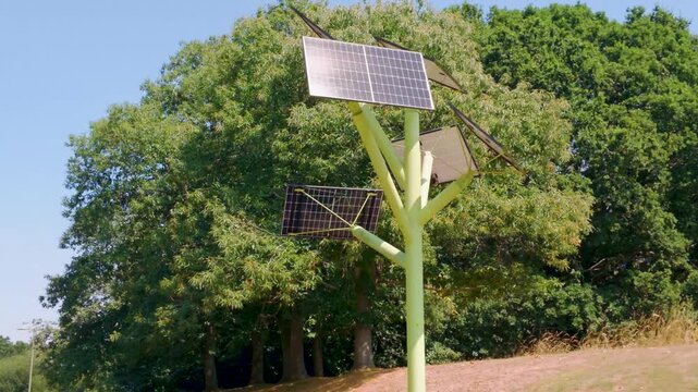 Multi-angle solar tree array low orbit, its panels tilted to capture sunlight at Southampton Science Park, England.