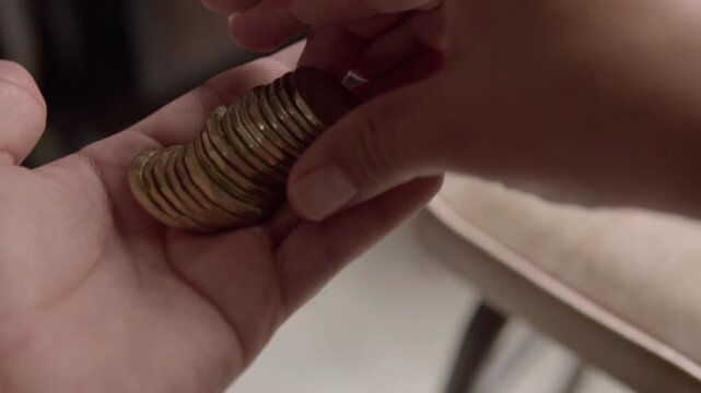 Closeup of hands counting Mexican peso coins for cash payment savings and everyday financial transactions. Money exchange and budgeting concept with national currency