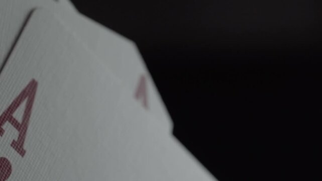 Macro close up of four aces playing cards fanned out, showcasing winning poker hand with sharp card symbols and selective focus for casino and gambling concepts