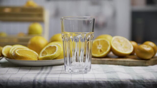 Orange juice bring pouring into glass near fruit - slow motion, medium shot