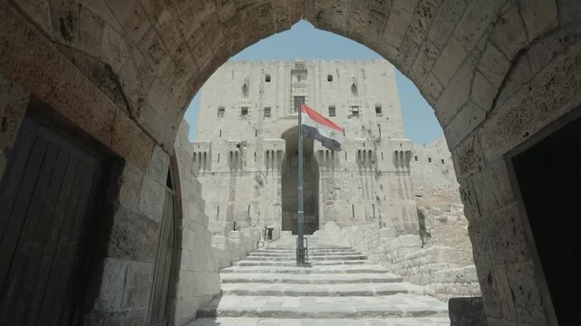 View of Syrian Flag Framed by Stone Archway Citadel Aleppo