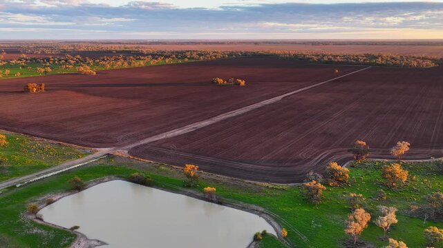 Aerial video flying over cultivated farmland at Pilliga, NSW, Australia. The cultivated soil creates striking natural patterns and textures