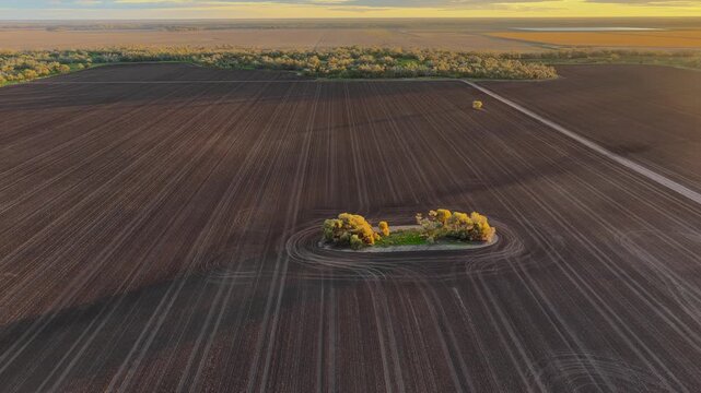 Aerial video flying over cultivated farmland at Pilliga, NSW, Australia. The cultivated soil creates striking natural patterns and textures
