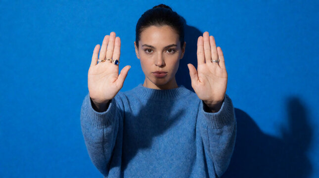 young woman showing stop sign