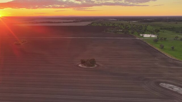 Aerial video flying over cultivated farmland at Pilliga, NSW, Australia. The cultivated soil creates striking natural patterns and textures