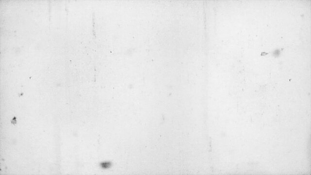 Vintage old film texture loop with heavy scratches, dust particles, and organic grain overlay on a light grayscale background