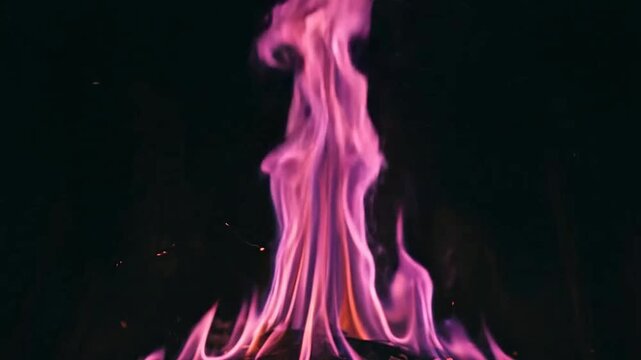 Vivid purple flames dancing in a dark background