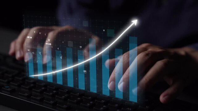 A close-up view of hands typing on a keyboard with a digital overlay showing growth metrics and financial icons, symbolizing data analysis and business success. Copula