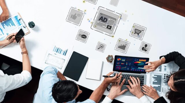 A dynamic workplace scene showcasing a diverse team collaborating on digital marketing strategies. The use of graphs and interactive icons illustrates modern analytical approaches. Raster