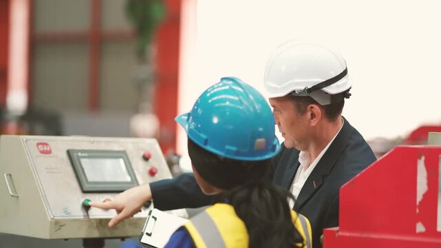Factory technicians inspecting metal sheet production line while reviewing technical document, manufacturing engineering, industrial operation, production planning, workplace teamwork.