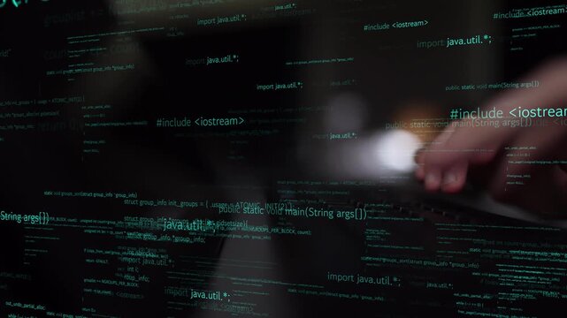 Close-up view of abstract programming code reflecting on a surface, with hands typing, emphasizing the role of technology in software development and problem-solving. Xenic