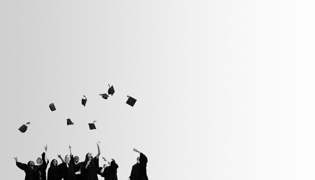 Graduates joyfully toss caps in the air against a white background.