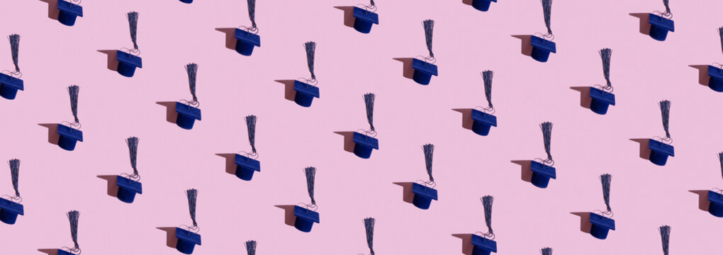 Blue graduation cap pattern on a pink background