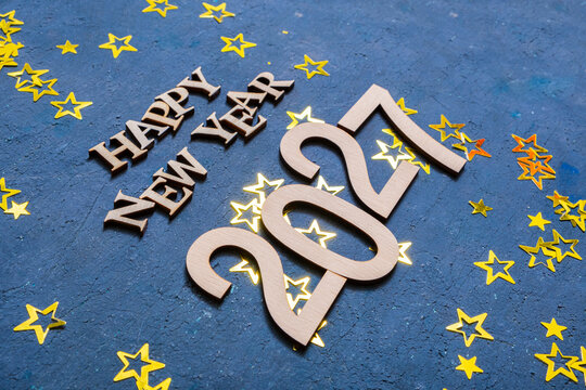 Celebrating new year 2027 with decorations and golden stars on a blue background
