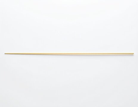 A single, thin, golden strand lies horizontally on a stark white surface