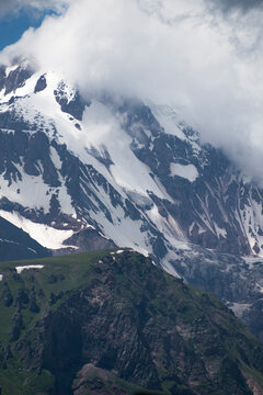 High Mount Kazbek slopes with snow and glaciers under storm clouds in Georgia with copy space