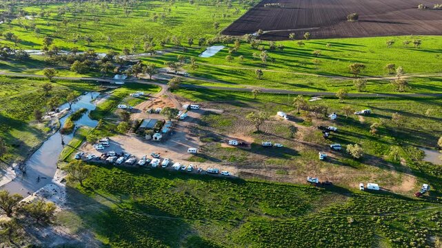 Aerial video flying over the Pilliga Artesian Bore Baths and adjacent campground in Pilliga, NSW, Australia. The naturally heated artesian baths are surrounded by native bushland