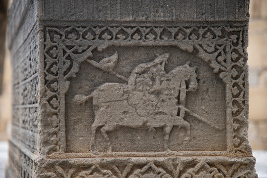 Ancient stone carving of horse rider bas relief in Old City of Baku Azerbaijan with copy space