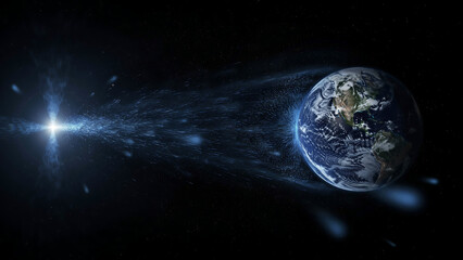 Naklejka premium Planet earth glowing in deep space with bright shining light rays and sparkling digital particles flying across the dark cosmic void showing a futuristic scientific technology concept