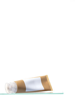 A premium skincare tube resting on its side. Ideal for showcasing a high-quality moisturizer, cream, or cleanser in advertisements and e-commerce visuals."