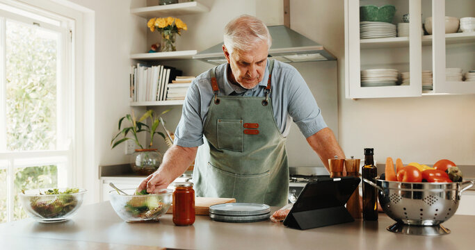 Tablet, recipe and senior man in kitchen with tutorial search, dinner method or online guide. Learning, instructions and old person in home with healthy ingredients, diet or steps in meal prep