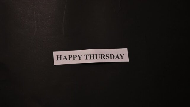 Happy Thursday Motivation Card Placed by Hand on Dark Minimal Background