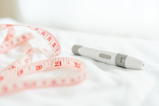 Medical slim pen close-up measuring tape. Concept of effective weight loss therapy, subcutaneous device and self-care.