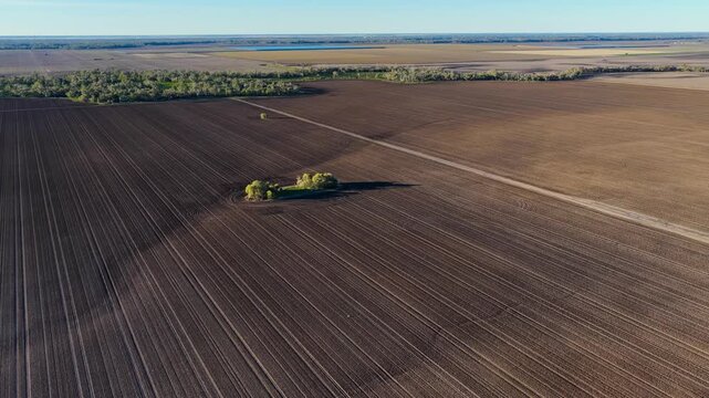 Aerial video flying over cultivated farmland at Pilliga, NSW, Australia. The cultivated soil creates striking natural patterns and textures