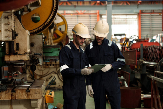 A team of engineers and staff are inspecting the production line system at a metal sheet and roofing factory. (PHOTO)	