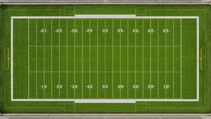 Fototapeta premium Aerial top-down view of an American football field with marked yard lines, goalposts, green turf, white markings and surrounding bleacher seating
