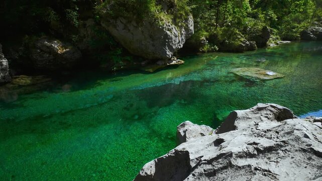 Fresh clear mountain water in a transparent turquoise pool among white rocks at Pozze Smeraldine.