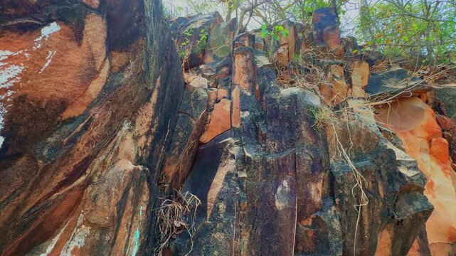 Tracking shot reveals steep vertical rock columns created by intense tectonic tilting where crustal forces uplifted fractured formations into striking geological patterns over millions of years