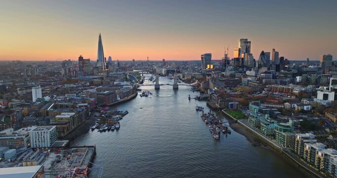Scenic aerial view of London City skyline at sunset. Featuring iconic landmarks like The Shard. Tower Bridge. And the financial district skyscrapers along the River Thames. Aerial view drone panorama