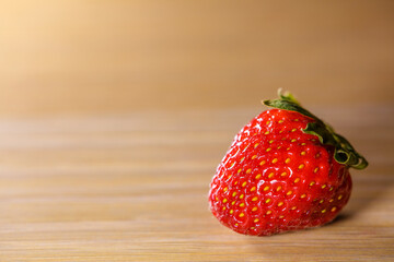 Single Fresh Ripe Red Strawberry on Right Side of Light Wooden Table with Copy Space © Екатерина Переславце